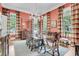 Formal dining room with decorative drapes, hardwood flooring and a gorgeous chandelier at 401 Ralston Creek St, Charleston, SC 29492