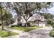 Exterior view of home with attached garage surrounded by mature trees at 401 Ralston Creek St, Charleston, SC 29492