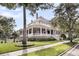 Stunning two-story home with a charming wrap-around porch and an American flag displayed at 401 Ralston Creek St, Charleston, SC 29492