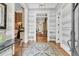 Inviting hallway with striped walls, hardwood floors, decorative rug, and multiple entryways at 401 Ralston Creek St, Charleston, SC 29492