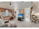 Comfortable living room with wood-paneled walls, neutral carpet, and a doorway leading to a bathroom at 401 Ralston Creek St, Charleston, SC 29492