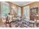 Comfortable living room with wood paneling, a plush sofa and view to outdoor balcony at 401 Ralston Creek St, Charleston, SC 29492