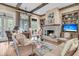 Comfortable living room with exposed beams, brick fireplace, hardwood floors, and stylish decor at 401 Ralston Creek St, Charleston, SC 29492