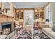 Cozy living room featuring a fireplace, custom built-ins and views to the gardens at 401 Ralston Creek St, Charleston, SC 29492