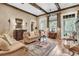 Cozy living room with exposed beams, hardwood floors, brick fireplace, and stylish furnishings at 401 Ralston Creek St, Charleston, SC 29492