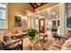 Inviting screened-in patio features comfortable seating and a glimpse into the beautifully lit interiors at 401 Ralston Creek St, Charleston, SC 29492