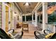 Relaxing porch with wicker chairs offering scenic views of the property and sunset at 401 Ralston Creek St, Charleston, SC 29492