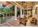 Expansive porch offers outdoor seating and an inviting view of the manicured grounds and home at 401 Ralston Creek St, Charleston, SC 29492