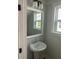 Well-lit bathroom featuring a pedestal sink with modern fixtures at 4126 O'Hear Ave, North Charleston, SC 29406