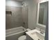 Bathroom showcasing tiled shower and tub, a modern sink and vanity, and a framed mirror at 4126 O'Hear Ave, North Charleston, SC 29406