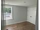 Bedroom with modern wood-look flooring, a double door closet, and a window providing natural light at 4126 O'Hear Ave, North Charleston, SC 29406