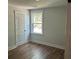 Bright bedroom features wood-look flooring and a large window offering plenty of natural light at 4126 O'Hear Ave, North Charleston, SC 29406