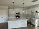 Modern kitchen with white cabinets, stainless steel appliances, and a center island at 4126 O'Hear Ave, North Charleston, SC 29406