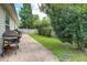 Spacious backyard featuring a patio, grilling area, and mature landscaping at 419 Equinox Cir, Ladson, SC 29456