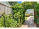 Charming backyard garden entrance with iron gate and lush greenery at 419 Equinox Cir, Ladson, SC 29456