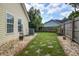 Green backyard with grass, rock border, landscaping, and view of the house at 419 Equinox Cir, Ladson, SC 29456