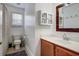 Bright bathroom with white walls, updated vanity, wood-trimmed mirror, and shower-tub combo at 419 Equinox Cir, Ladson, SC 29456