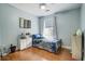 Cozy bedroom with hardwood floors, blue walls, ceiling fan, and window with blinds at 419 Equinox Cir, Ladson, SC 29456
