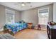 Comfortable bedroom with wood floors, neutral walls, two windows, and fan at 419 Equinox Cir, Ladson, SC 29456