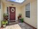 Inviting entryway with a decorative wreath on the front door and potted plants at 419 Equinox Cir, Ladson, SC 29456