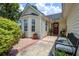 Charming front porch with a bench, potted plants, and decorative wreath on the door at 419 Equinox Cir, Ladson, SC 29456