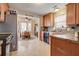 Charming kitchen showcases beautiful wood cabinetry, tile flooring, and an open layout leading to the dining area at 419 Equinox Cir, Ladson, SC 29456