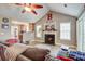 Inviting living room featuring a fireplace, large windows, and an open view to the kitchen at 419 Equinox Cir, Ladson, SC 29456
