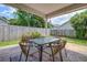 Covered patio featuring a stone-like floor, outdoor table with seating, and garden view at 419 Equinox Cir, Ladson, SC 29456
