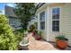 Cozy side yard featuring a stone pathway lined with potted plants and lush greenery at 419 Equinox Cir, Ladson, SC 29456