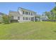 Spacious backyard with manicured lawn, back porch, and hot tub, perfect for outdoor entertaining at 420 Oak View Way, Summerville, SC 29483