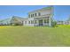 Large, lush backyard with a covered patio and a hot tub, ideal for relaxation and recreation at 420 Oak View Way, Summerville, SC 29483