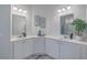 Bright bathroom featuring double sinks with white countertops, framed botanical art, and decorative plant at 420 Oak View Way, Summerville, SC 29483