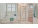 Serene bathroom with a soaking tub, glass shower door, and window with light-filtering shutters at 420 Oak View Way, Summerville, SC 29483