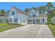 Charming two-story home featuring a spacious driveway, white siding, and delightful blue shutters and front door at 420 Oak View Way, Summerville, SC 29483