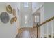 Bright foyer featuring high ceilings, hardwood floors, decorative wall baskets, and a welcoming entrance at 420 Oak View Way, Summerville, SC 29483