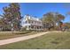 Stunning two-story historic home with a beautiful landscaped lawn, sidewalk, and mature trees at 420 Oak View Way, Summerville, SC 29483