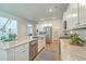 A kitchen with a large island, stainless steel appliances, and white cabinets is shown at 420 Oak View Way, Summerville, SC 29483