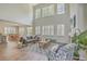 Bright living room with high ceilings, large windows, hardwood floors, and comfortable seating area with fireplace at 420 Oak View Way, Summerville, SC 29483