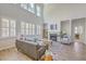 Elegant living room featuring tall windows, fireplace, hardwood floors, and stylish furniture for relaxed living at 420 Oak View Way, Summerville, SC 29483