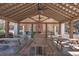 Spacious outdoor pavilion with picnic tables, a brick fireplace, and a ceiling fan at 420 Oak View Way, Summerville, SC 29483