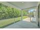 Screened in porch with a view of lush green landscaping, a hot tub and white siding home at 420 Oak View Way, Summerville, SC 29483