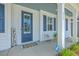 Cozy front porch with a blue door, ADT security sign, and a charming welcome mat and seating at 420 Oak View Way, Summerville, SC 29483