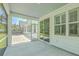 Screened in porch with a view of a house with white siding, windows, landscaping and a hot tub at 420 Oak View Way, Summerville, SC 29483