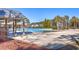 Large community pool area with covered seating, lounge chairs, and lush landscaping at 420 Oak View Way, Summerville, SC 29483