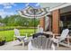 Inviting back patio with comfortable seating, an umbrella, and a beautiful view of the lake at 5394 Clairmont Ln, North Charleston, SC 29420
