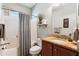 Neutral bathroom featuring granite counters, cherry cabinets, and shower with curtain at 5394 Clairmont Ln, North Charleston, SC 29420