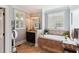 Luxurious bathroom boasting a soaking tub, granite countertops, and custom fixtures at 5394 Clairmont Ln, North Charleston, SC 29420