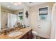 Bright bathroom features granite countertop, cherry cabinets and a large framed mirror at 5394 Clairmont Ln, North Charleston, SC 29420
