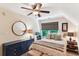 Serene bedroom featuring a ceiling fan, bedside tables, and a round mirror on the wall at 5394 Clairmont Ln, North Charleston, SC 29420