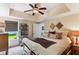 Bright bedroom featuring ceiling fan, natural light, and decorated wall art pieces at 5394 Clairmont Ln, North Charleston, SC 29420